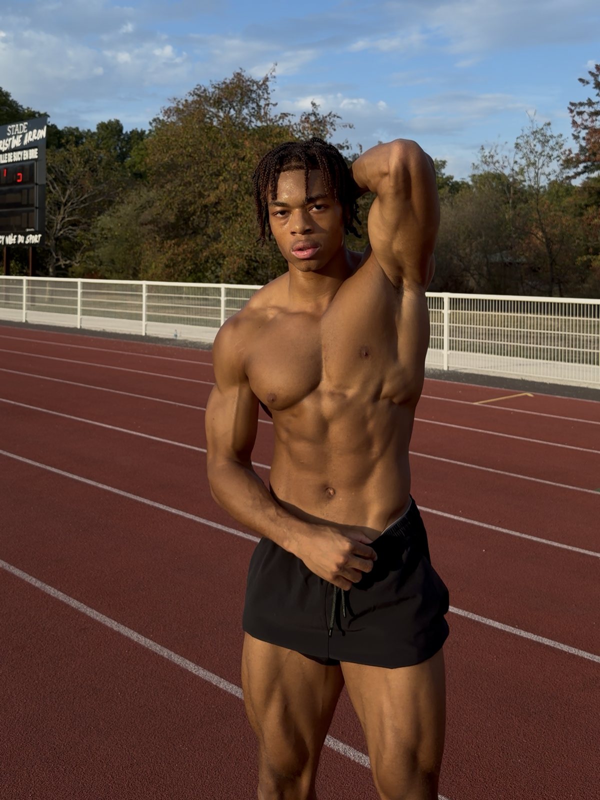 Kevin Nguena on a running track at golden hour
