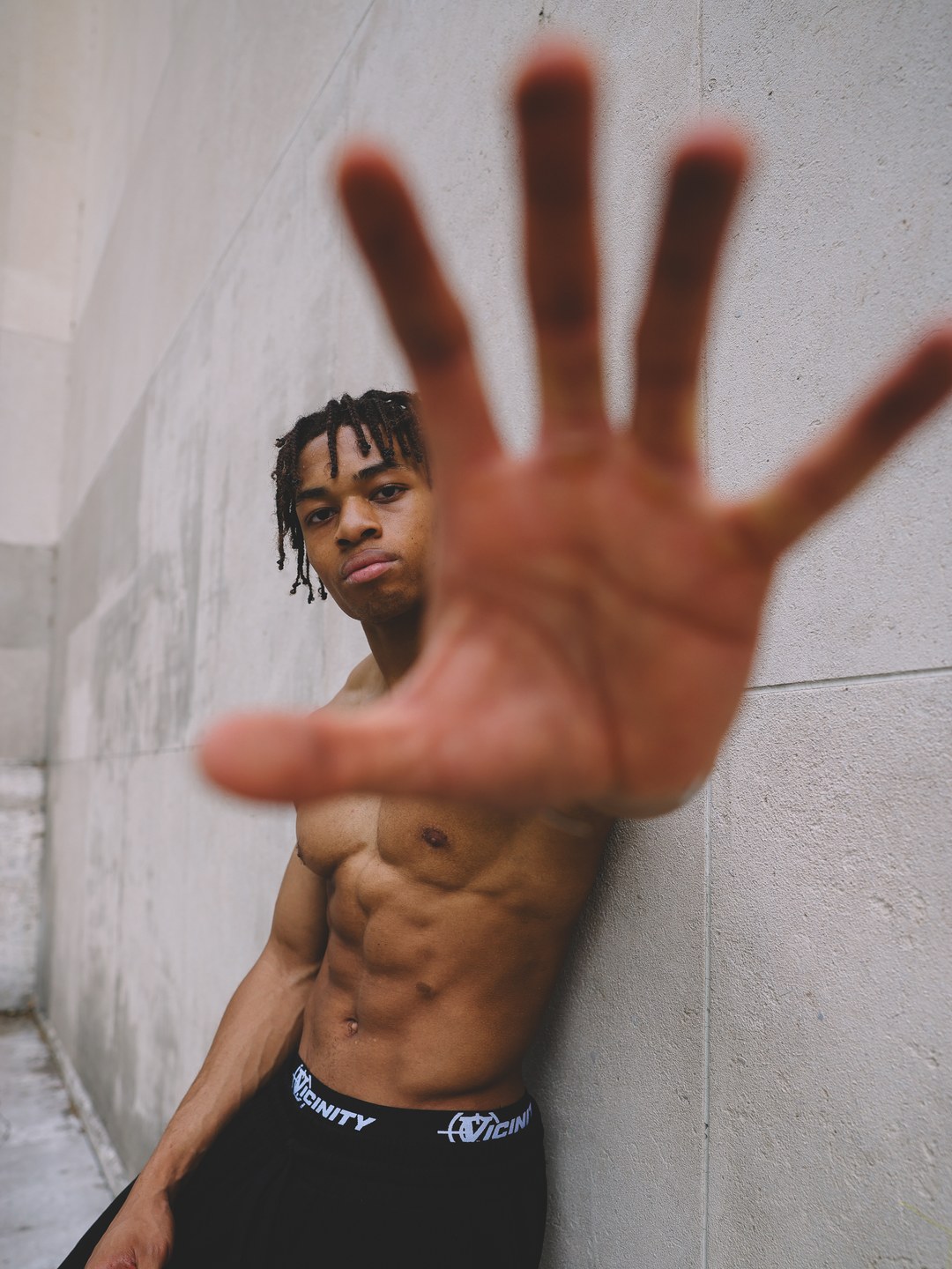 Kevin Nguena, full physique, hand held out to the camera